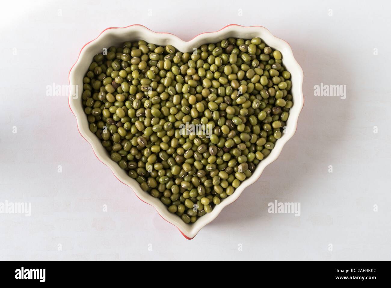 Uncooked Green Gram in a Heart Shape Stock Photo