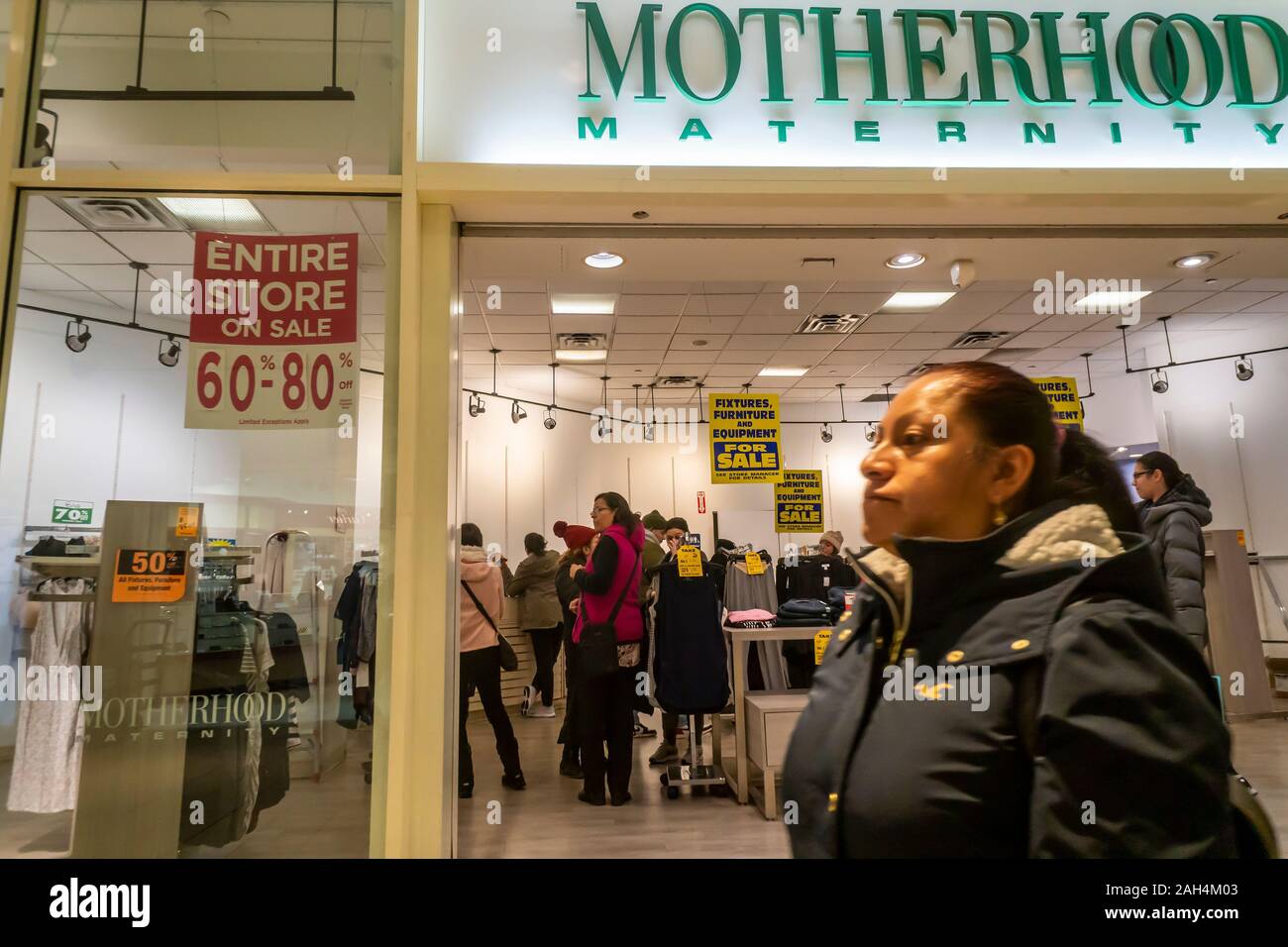 The Motherhood Maternity store announces its closing sales in the Queens Center Mall in the borough of Queens in New York on so-called Super Saturday. the Saturday prior to Christmas, December 21, 2019. Motherhood Maternity is a brand of Destination Maternity which filed for bankruptcy protection earlier this year and is closing 183 stores. (© Richard B. Levine) Stock Photo