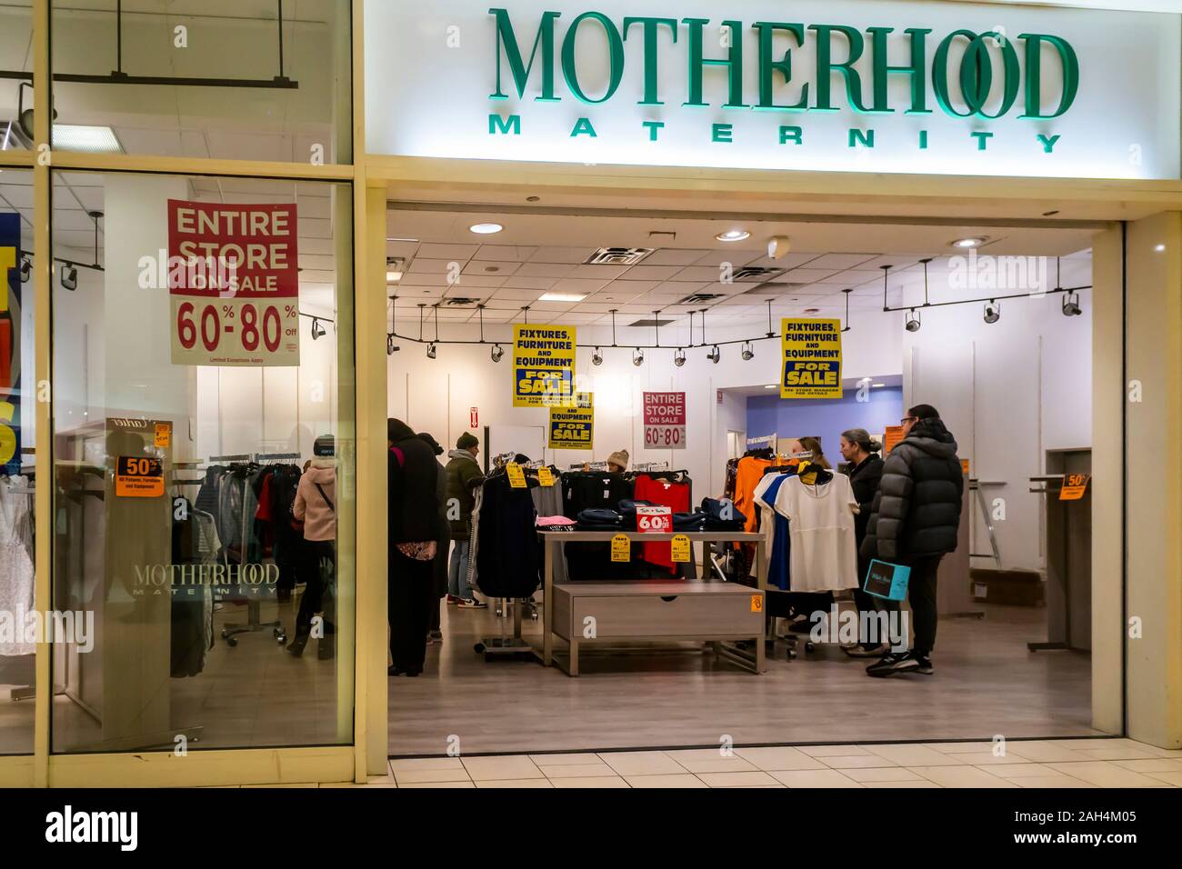 The Motherhood Maternity store announces its closing sales in the Queens Center Mall in the borough of Queens in New York on so-called Super Saturday. the Saturday prior to Christmas, December 21, 2019. Motherhood Maternity is a brand of Destination Maternity which filed for bankruptcy protection earlier this year and is closing 183 stores. (© Richard B. Levine) Stock Photo