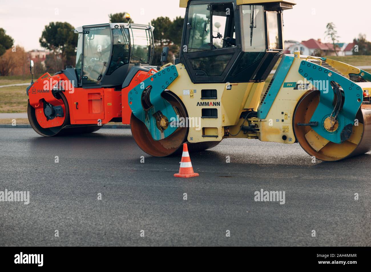 Asphalt paving. Paver machine and road roller. New road construction. Stock Photo