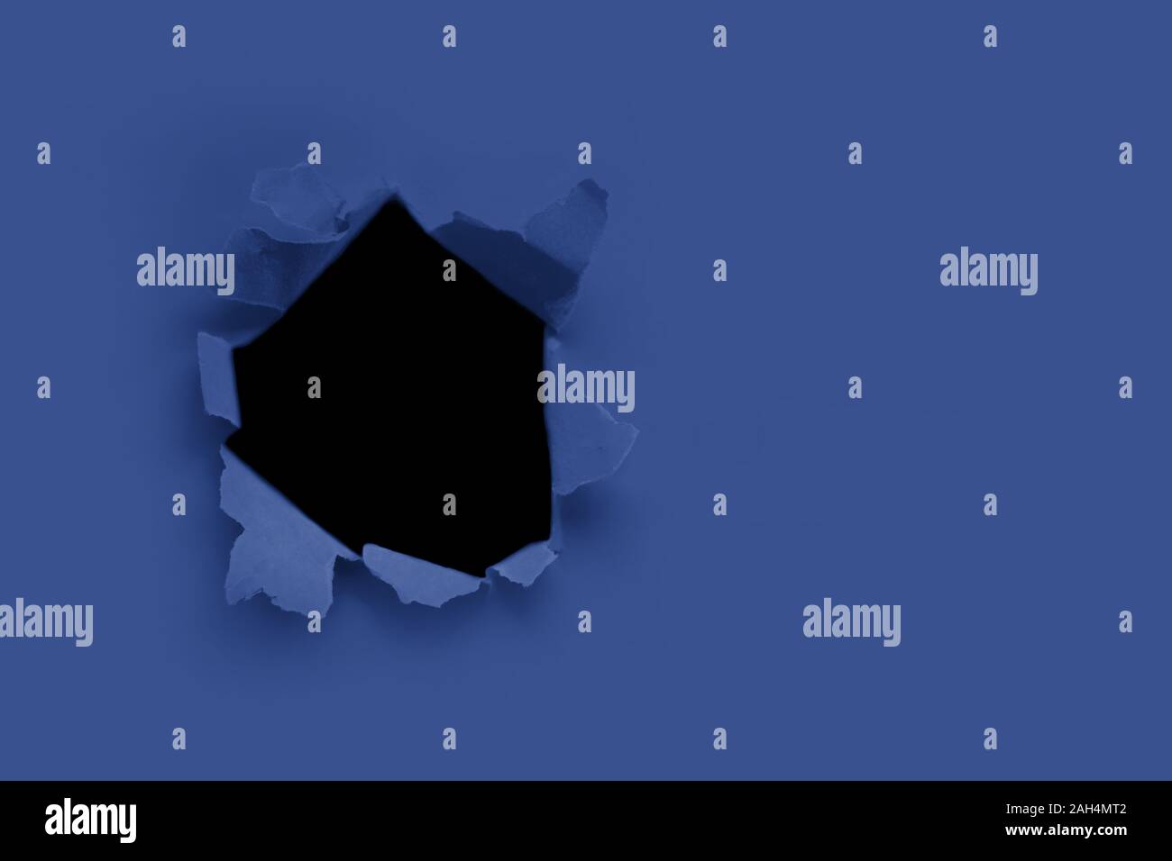 Breakthrough paper hole with black background toned with main trendy ...