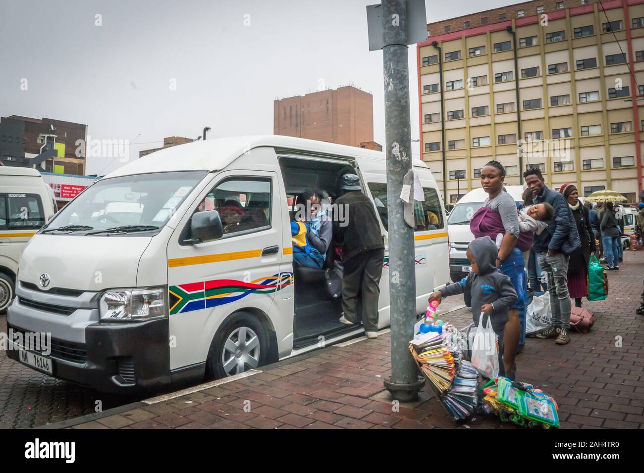Johannesburg, South Africa - December 5, 2019 - bus station in the city centre; passenger wait for a taxi bus Stock Photo