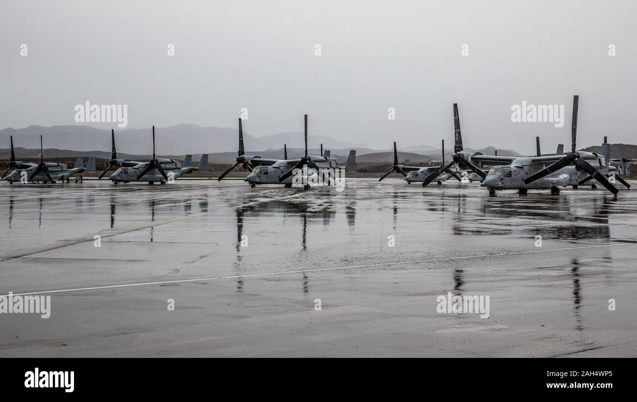 U.S. Marine MV-22B Osprey tiltrotor aircraft  sit in the rain on Marine Corps Air Station Camp Pendleton, California, Dec. 23, 2019. MCAS Camp Pendleton operates and maintains a secure airfield in order to support I Marine Expeditionary Force, Marine Corps Base Camp Pendleton tenant commands and visiting units to maintain and enhance their mission capabilities and combat readiness. (U.S. Marine Corps photo by Lance Cpl. Alison Dostie) Stock Photo