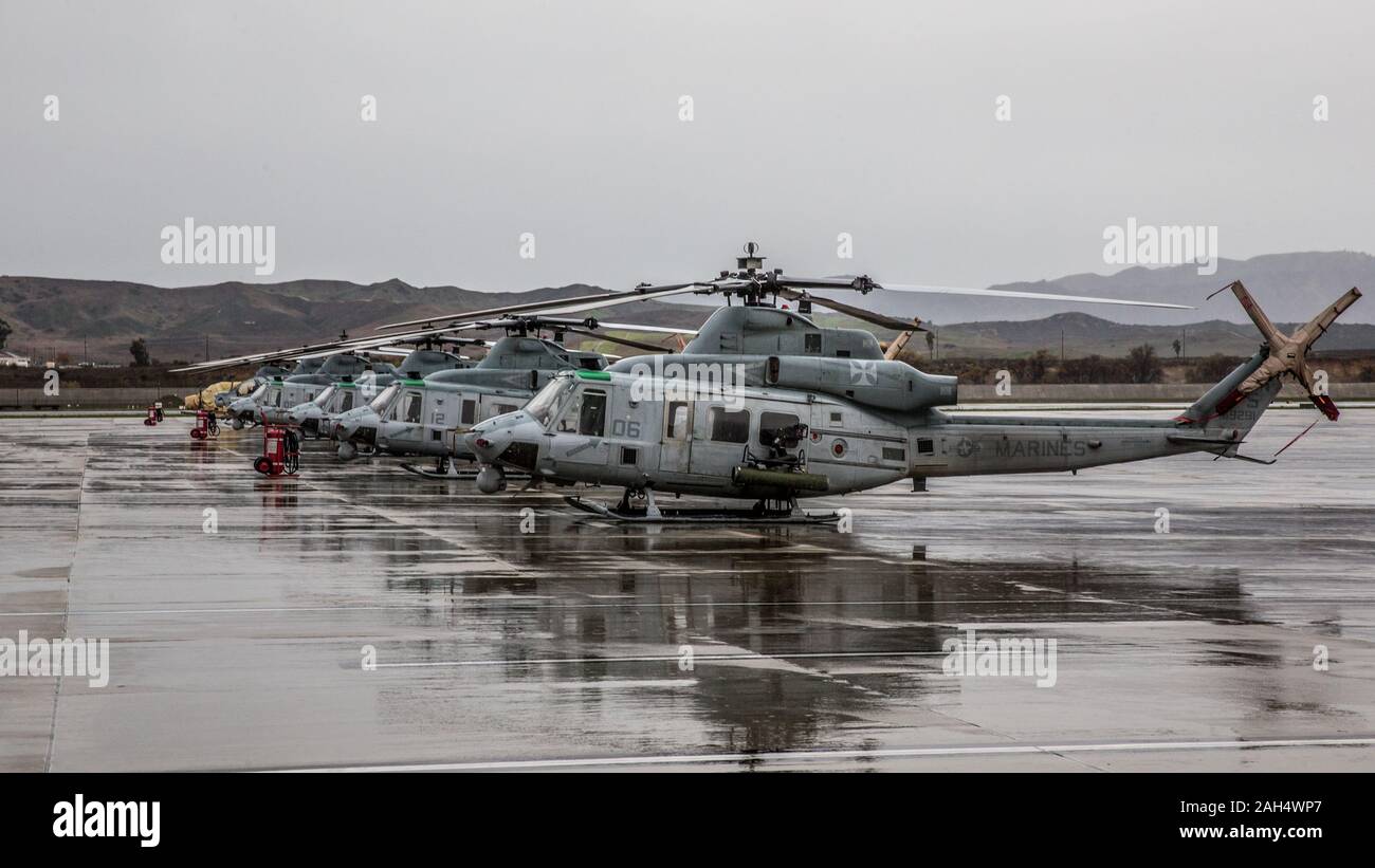 U.S. Marine UH-1Y Venom helicopters sit in the rain on Marine Corps Air Station Camp Pendleton, California, Dec. 23, 2019. MCAS Camp Pendleton operates and maintains a secure airfield in order to support I Marine Expeditionary Force, Marine Corps Base Camp Pendleton tenant commands and visiting units to maintain and enhance their mission capabilities and combat readiness. (U.S. Marine Corps photo by Lance Cpl. Alison Dostie) Stock Photo
