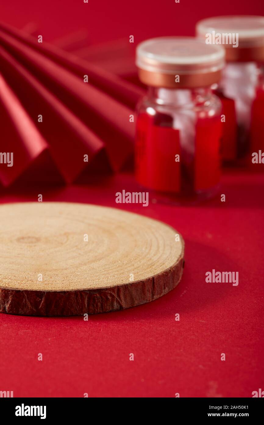 Chinese wind red background and red folding fan and red medicine bottle and tree slice coaster Stock Photo