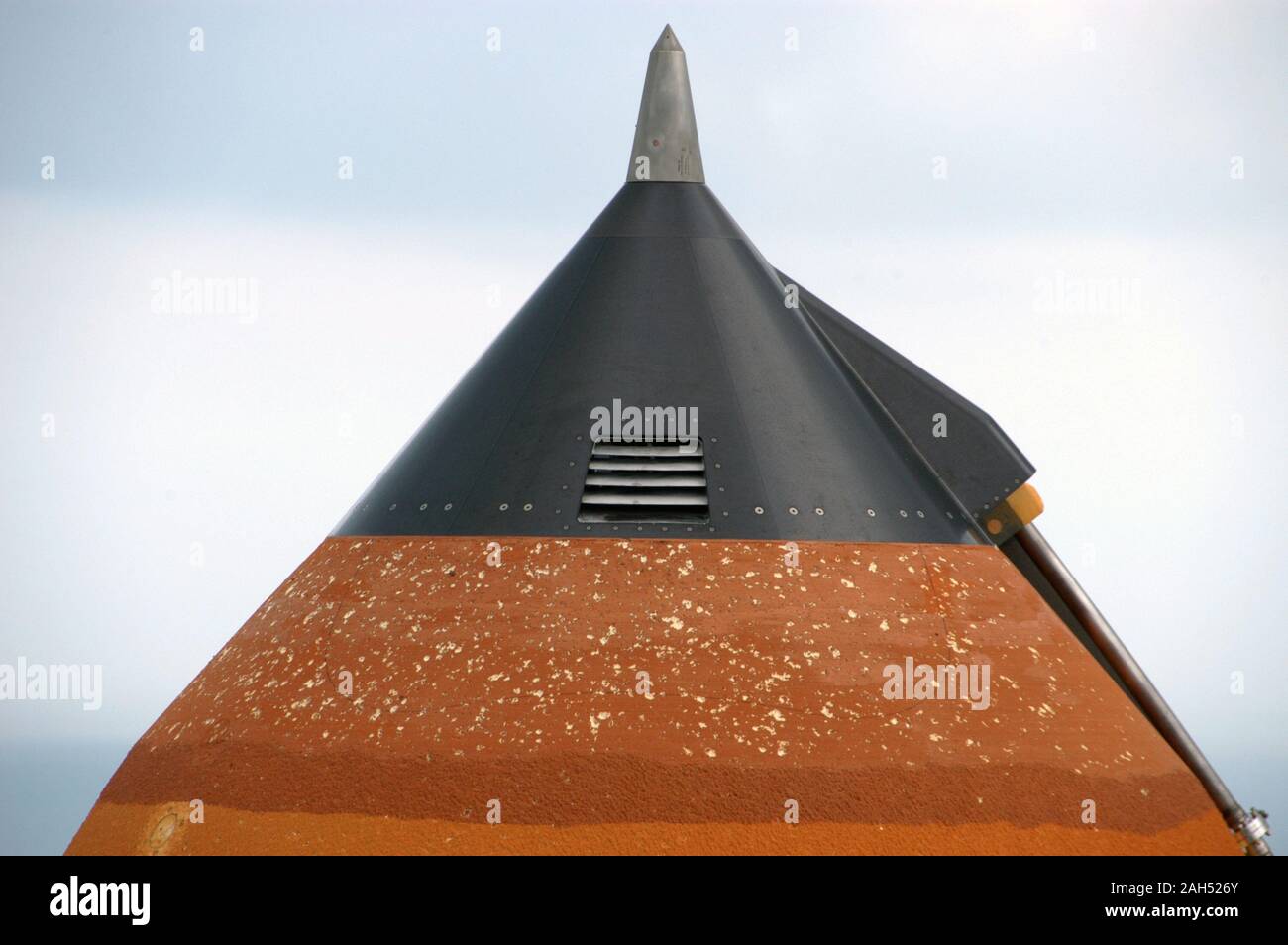 At Launch Pad 39A, the external tank attached to Space Shuttle Atlantis shows damage from hail bombardment during a strong thunderstorm that passed through Kennedy Space Center about 5 p.m. EST on Feb. 26. Stock Photo