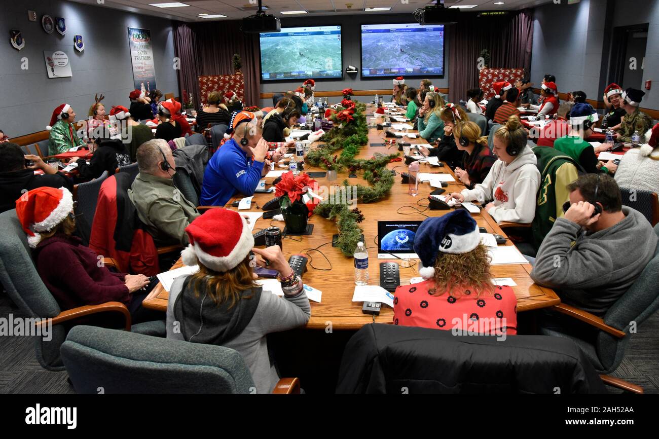Colorado Springs, United States. 24 December, 2019. Military and civilians volunteer as Santa Trackers at the 2019 NORAD Tracks Santa Operation Center at Peterson Air Force Base December 24, 2019 in Colorado Springs, Colorado. The North American Aerospace Defense Command volunteers to answer 137,000 phone calls and 4,900 emails from children around the world asking where Santa is and when will he arrive at their house. Credit: Alexandra M. Longfellow/Planetpix/Alamy Live News Stock Photo