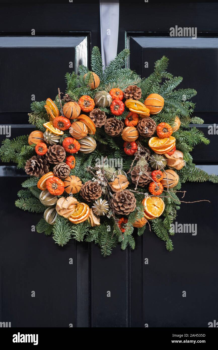 Christmas wreath on a black wooden house door. London, England Stock Photo