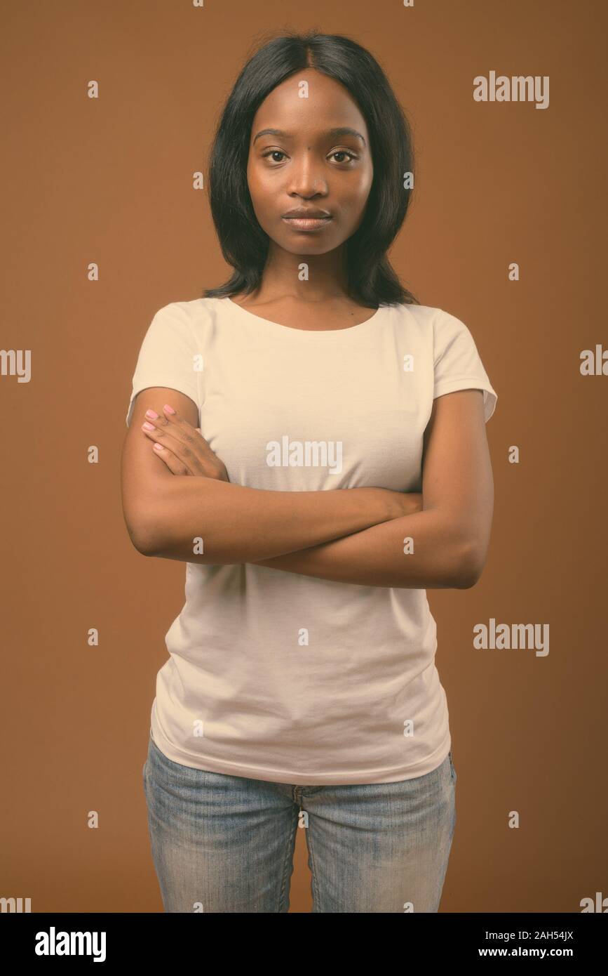 Studio shot of young beautiful African Zulu woman wearing white shirt ...