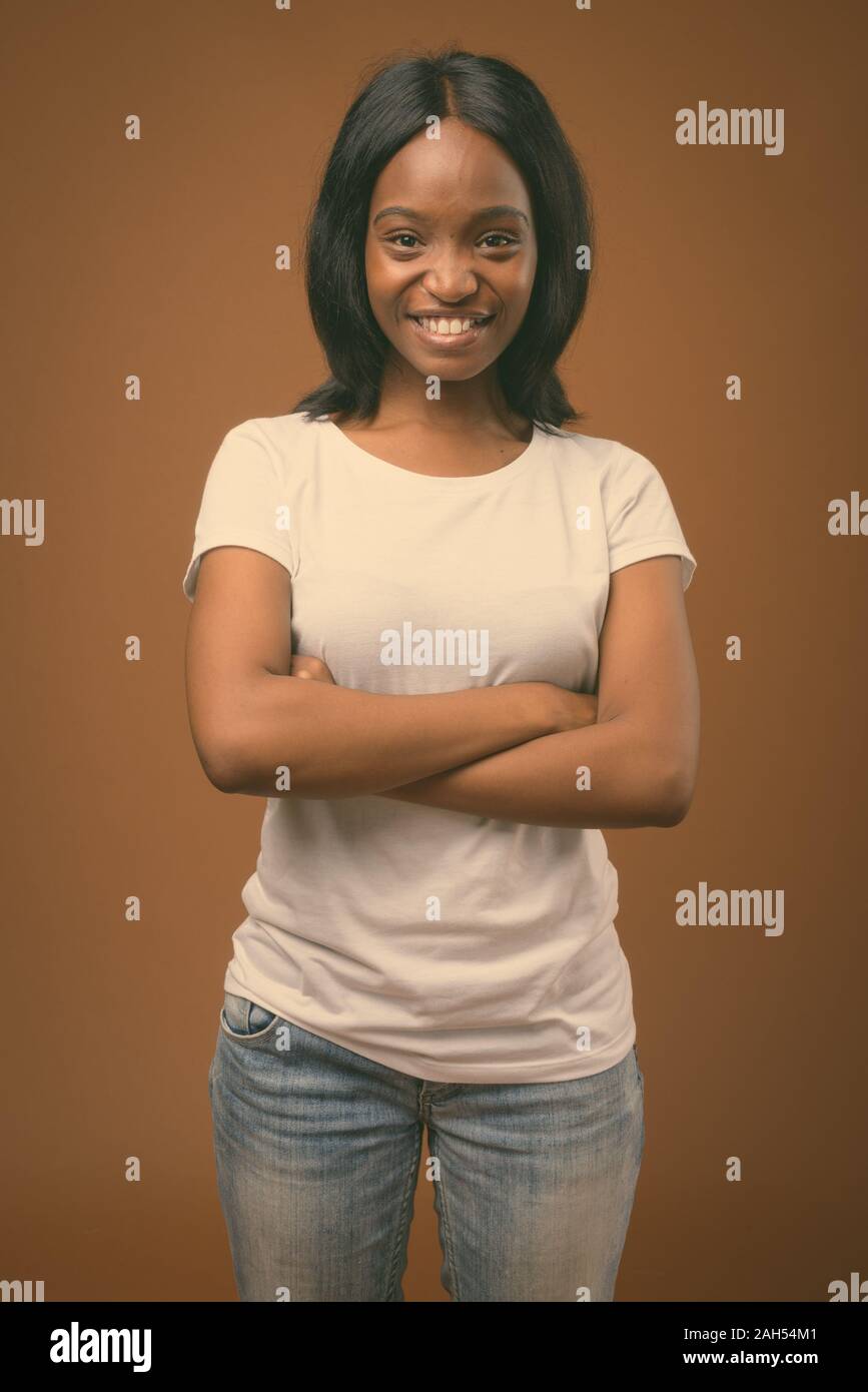 Studio shot of young beautiful African Zulu woman wearing white shirt ...