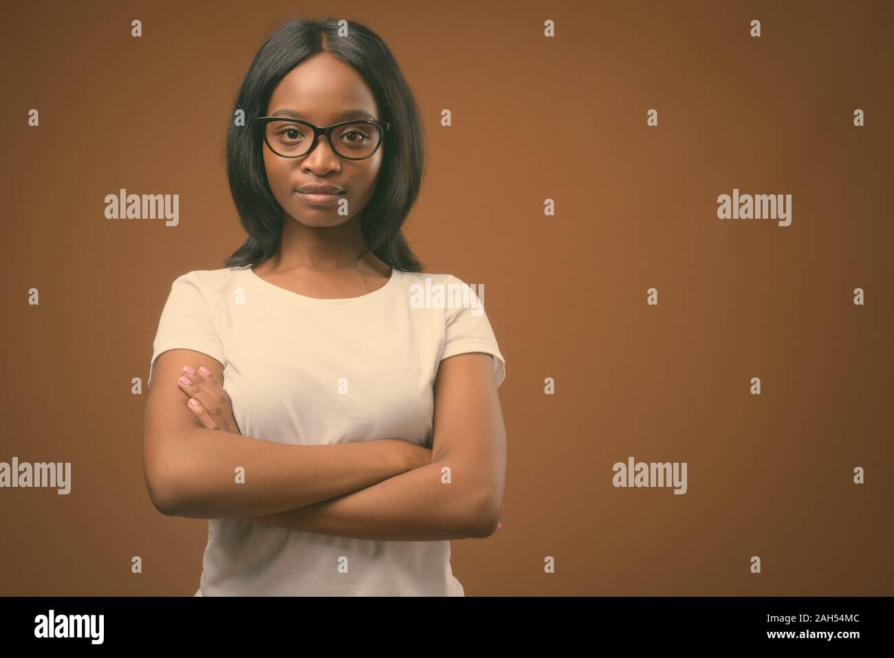 Studio shot of young beautiful African Zulu woman wearing white shirt ...