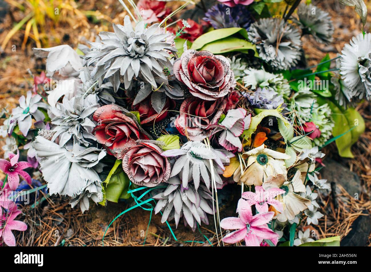 old grave multicolored fading flowers on a grave Stock Photo Alamy