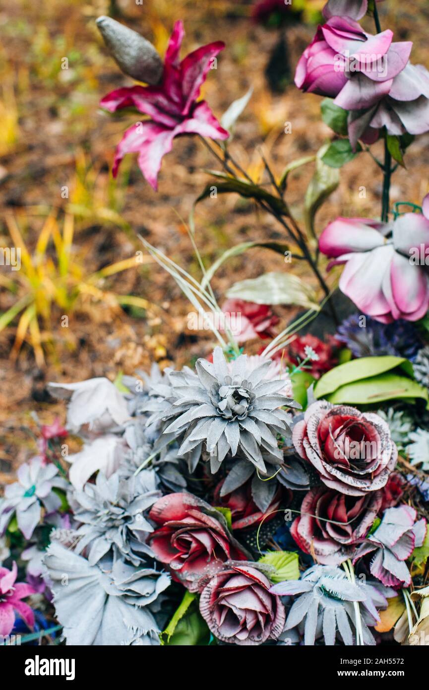 old grave multicolored fading flowers on a grave Stock Photo Alamy