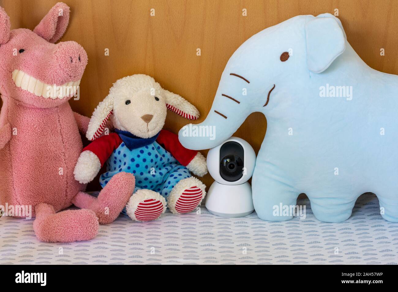 IP camera monitoring in a baby crib with children toys Stock Photo