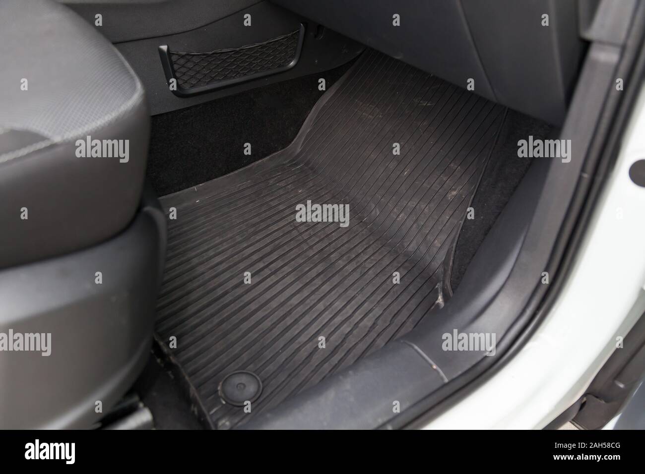 Dirty car floor mats of black rubber under passenger seat in the workshop  for the detailing vehicle before dry cleaning. Auto service industry.  Interi Stock Photo - Alamy