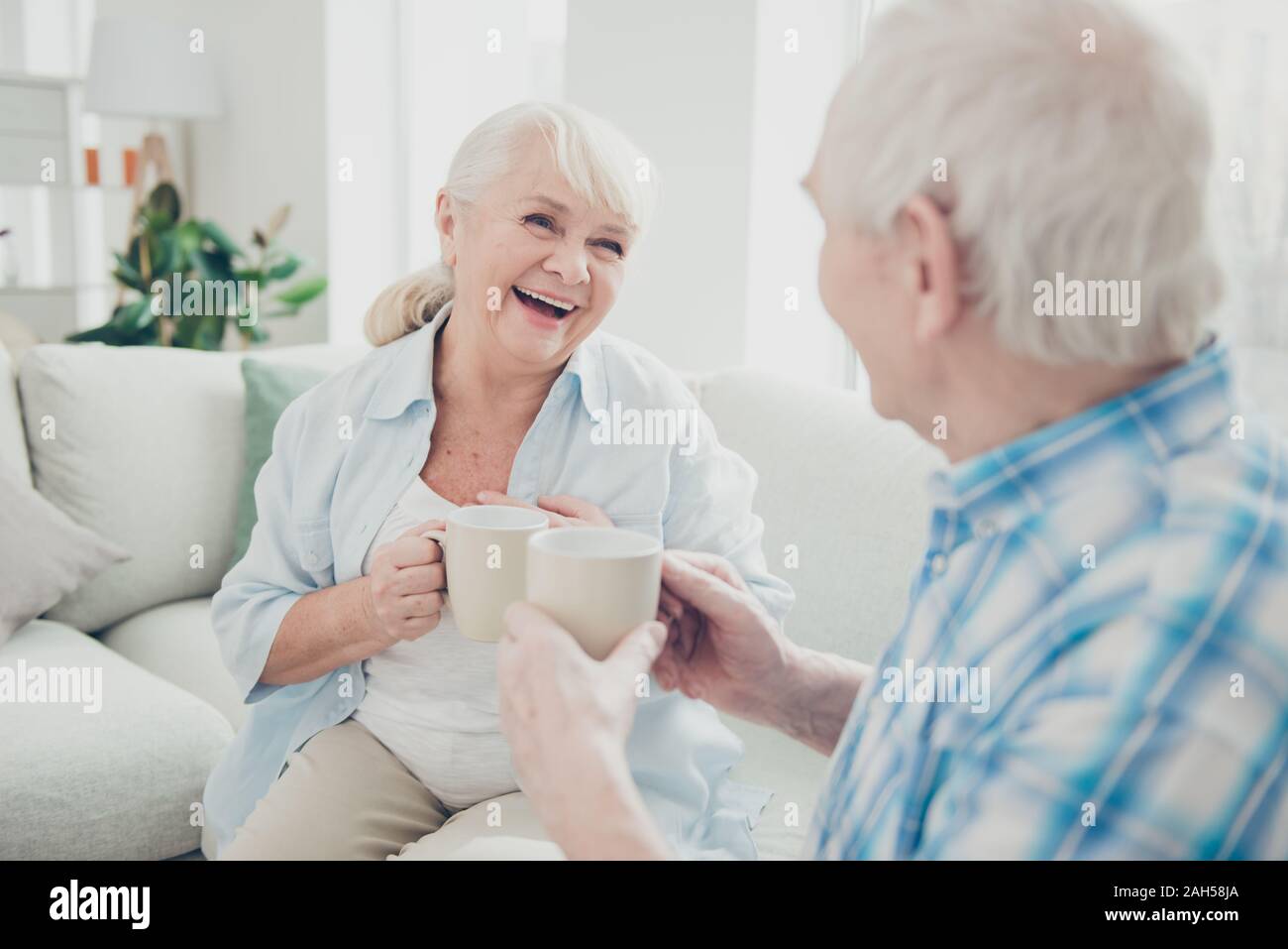 Portrait of her she his he two nice attractive cheerful cheery glad positive spouses, discussing news having fun morning spending time joking in light Stock Photo
