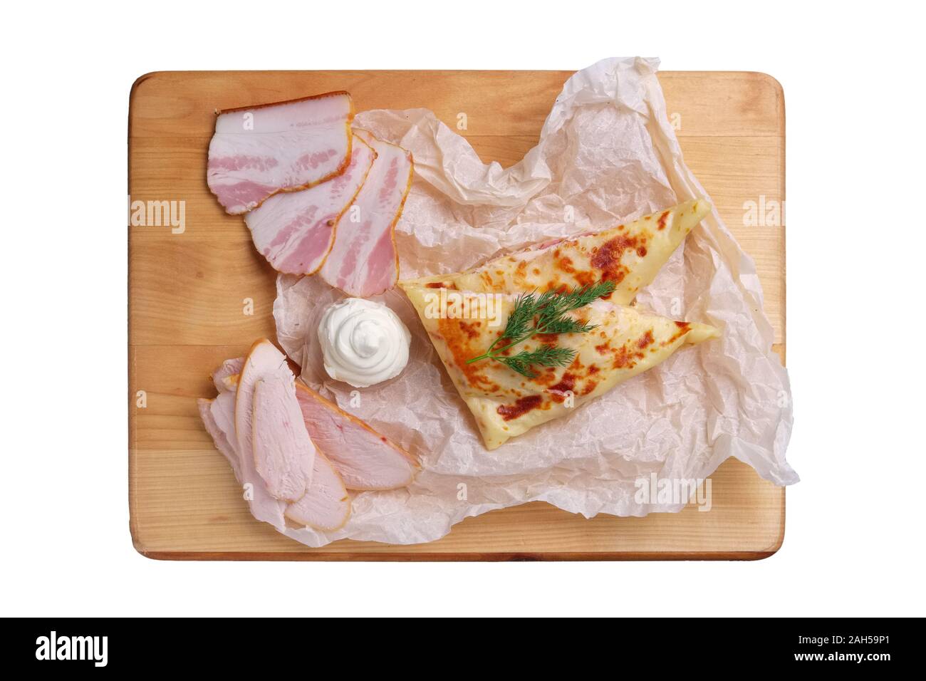 Thin pancakes stuffed with ham and bacon isolated on white Stock Photo