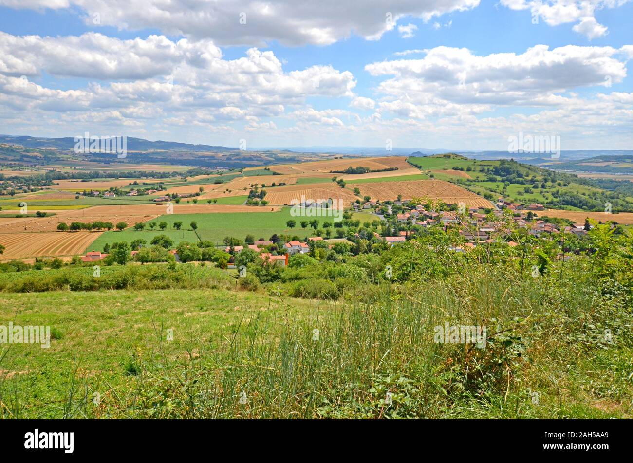 Beautiful rural landscape with blue sky, spectacular clouds and wheat fields in Auvergne region in France Stock Photo