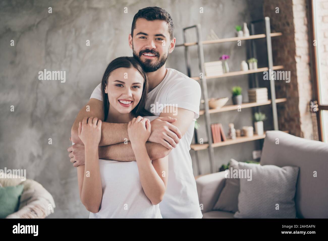 Portrait of two nice attractive lovely stylish cheerful cheery positive, gentle confident people sending free time at industrial loft interior style r Stock Photo