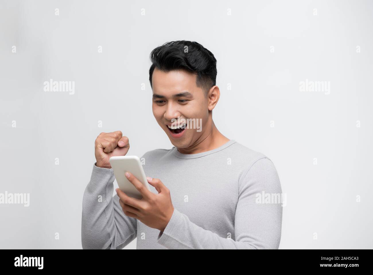 Young happy man using hi-res stock photography and images - Alamy