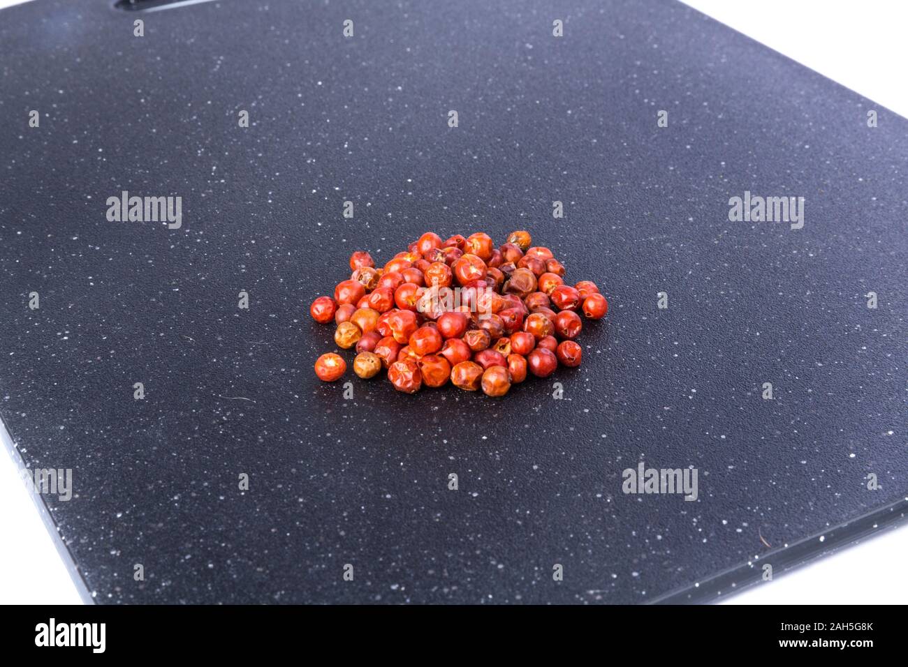 Handful of red spicy tiny round chile tepin peppers Stock Photo