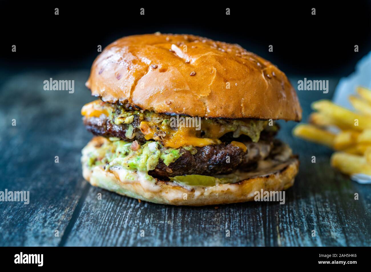 Hamburger with Guacamole Dip Sauce / Guacamole Burger. Fast Food. Stock Photo