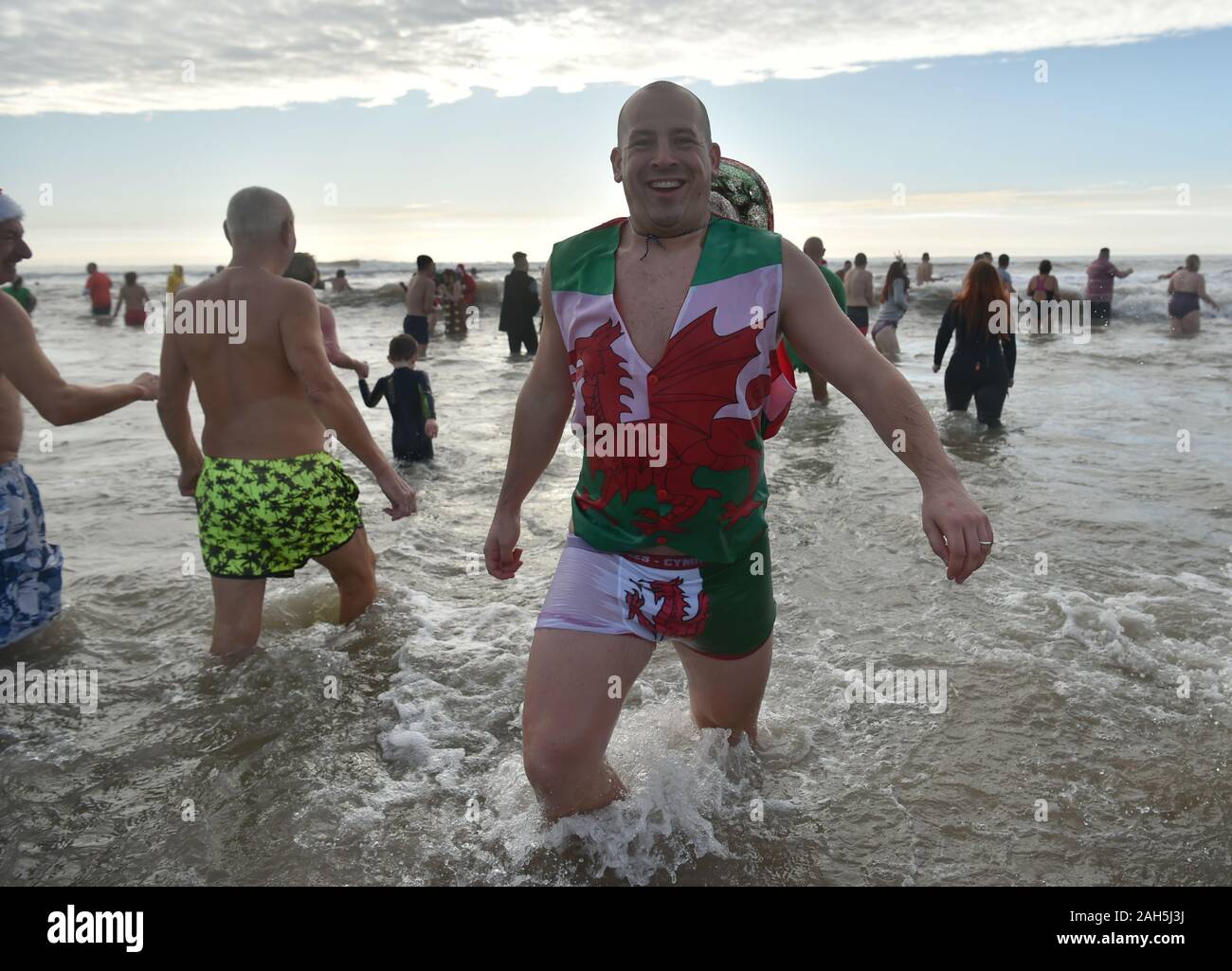 Swimmers take part in the Christmas Day swim in Porthcawl, Wales. Stock Photo