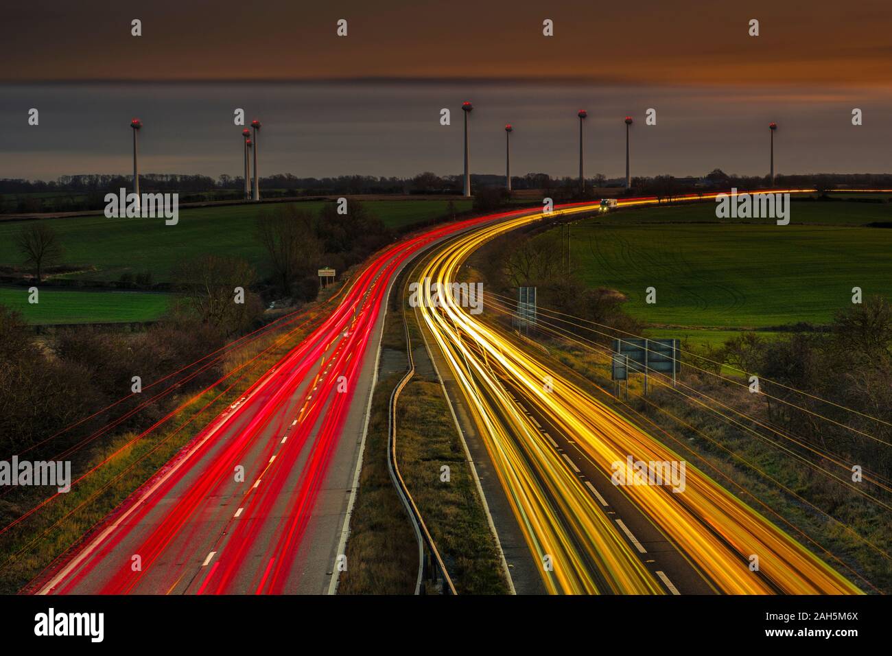 Light trails of vehicles on a busy dual carriageway at nightfall. Stock Photo