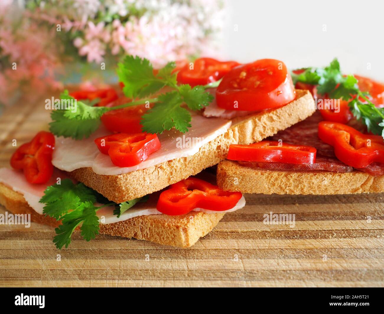 White bread sandwiches with pastrami and vegetables. Stock Photo