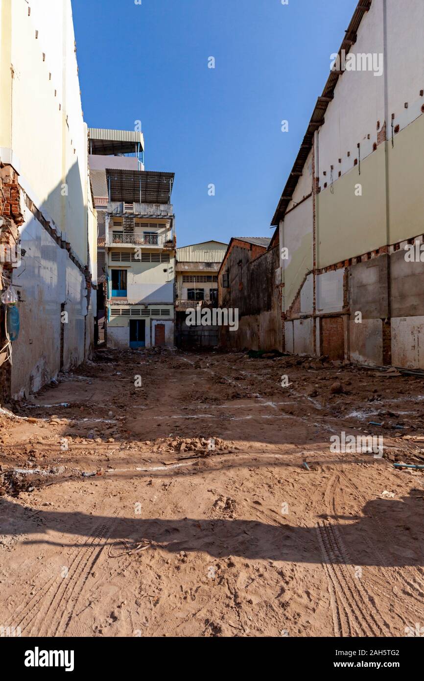 A vacant plot of land awaits the construction of a new shophouse on a city street in Kampong Cham, Cambodia. Stock Photo
