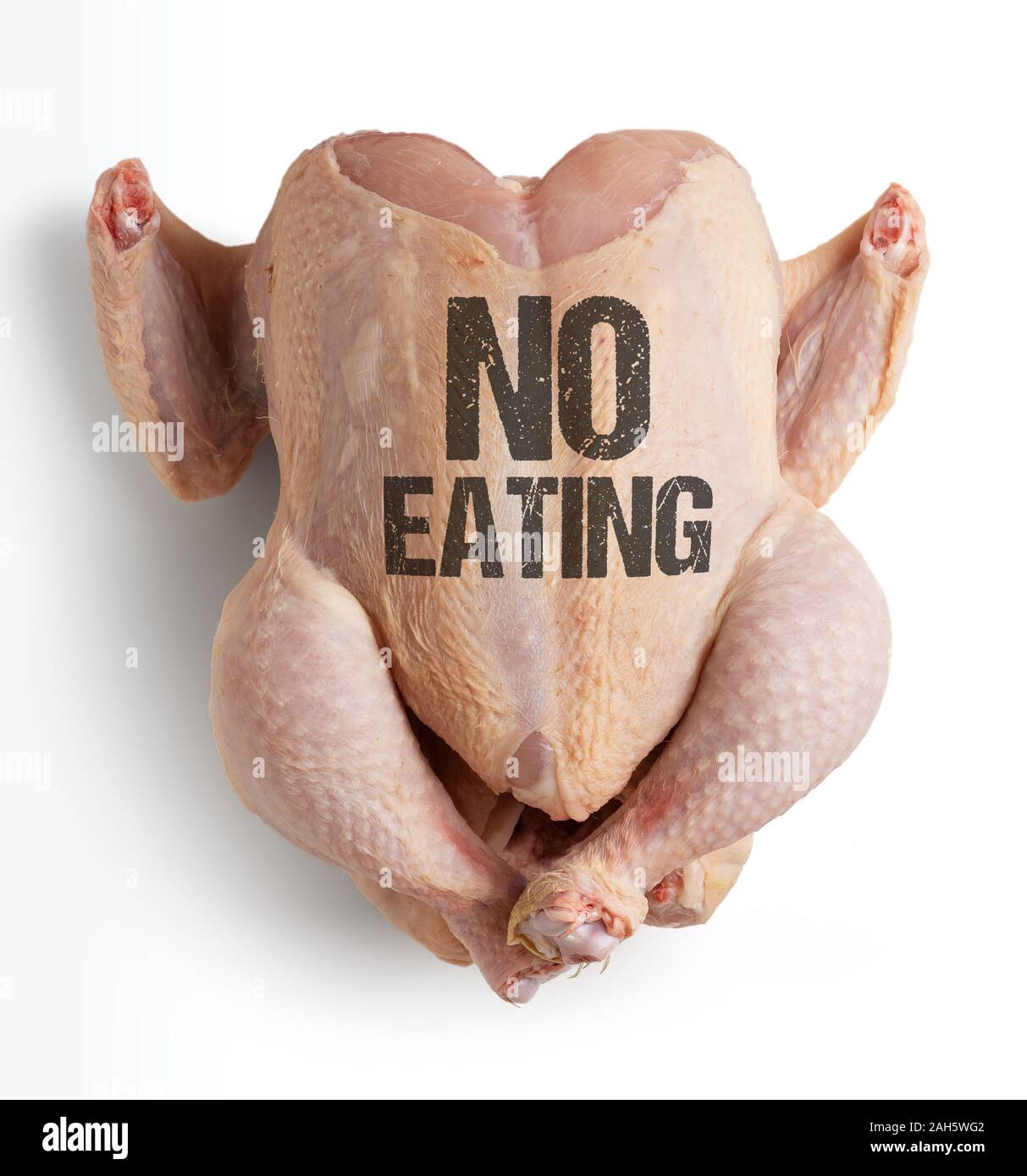 Raw chicken with conceptual message for vegans 'No eating' contains clipping path Stock Photo