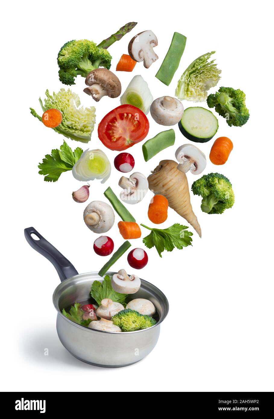 Fresh vegetables flying in a pot, isolated on white background. Stock Photo