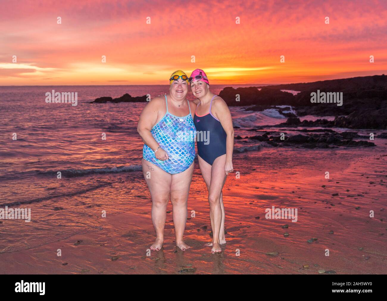 Myrtleville, Cork, Ireland. 25th December, 2019. Marie Watson, Carrigaline and Brenda Sisk from Tivoli preparing to go in for an early morning Christmas Day swim before dawn at Myrtleville, Co. Cork, Ireland.- Credit; David Creedon / Alamy Live News Stock Photo
