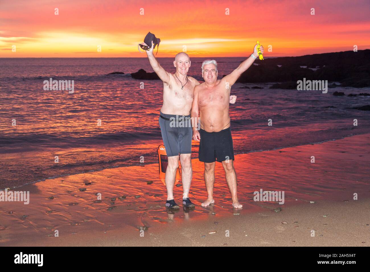 Myrtleville, Cork, Ireland. 25th December, 2019. Michael Looney, Kerry Pike and John Sisk, Tivoli preparing to go in for an early morning Christmas Day swim before dawn at Myrtleville, Co. Cork, Ireland.- Credit; David Creedon / Alamy Live News Stock Photo