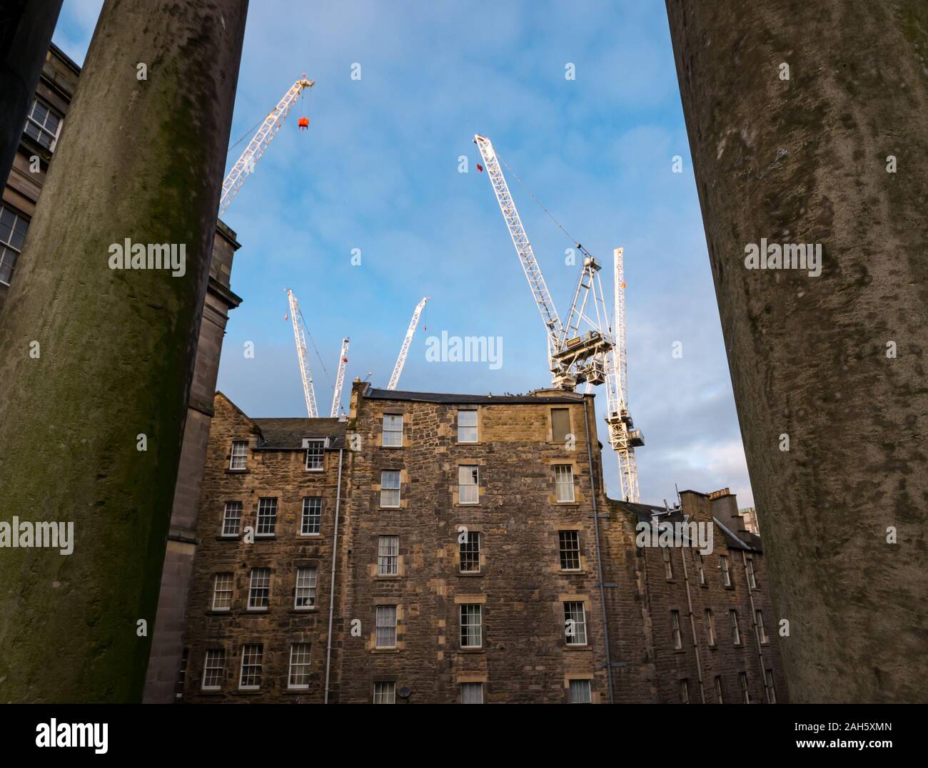 View through Regent Bridge pillars of St James Centre cranes and tenement buildings, Edinburgh, Scotland, UK Stock Photo