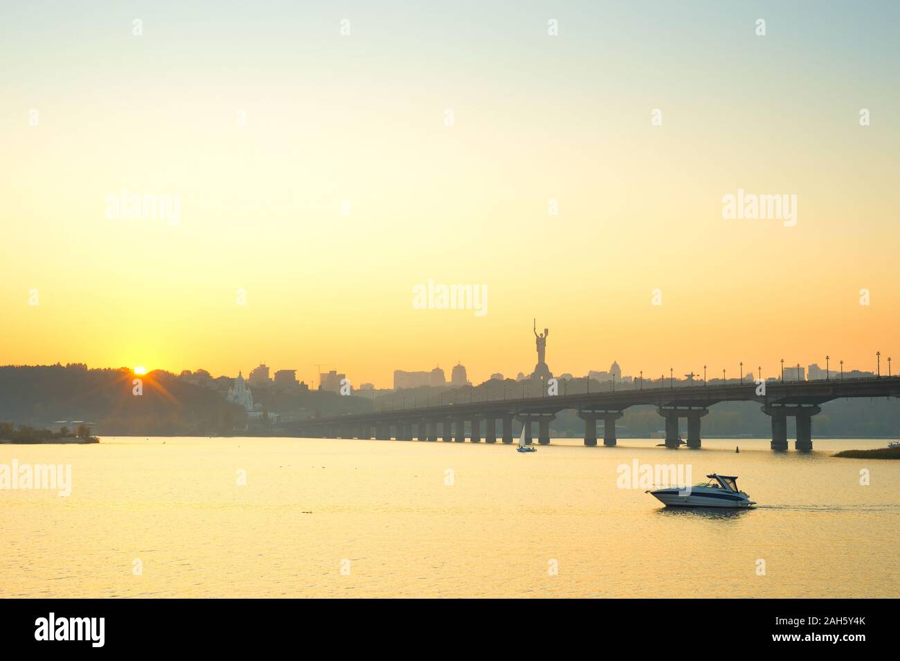 View of Mother Motherland monument, motor boat on Dnipro river, Paton bridge. Kiev, Ukraine Stock Photo