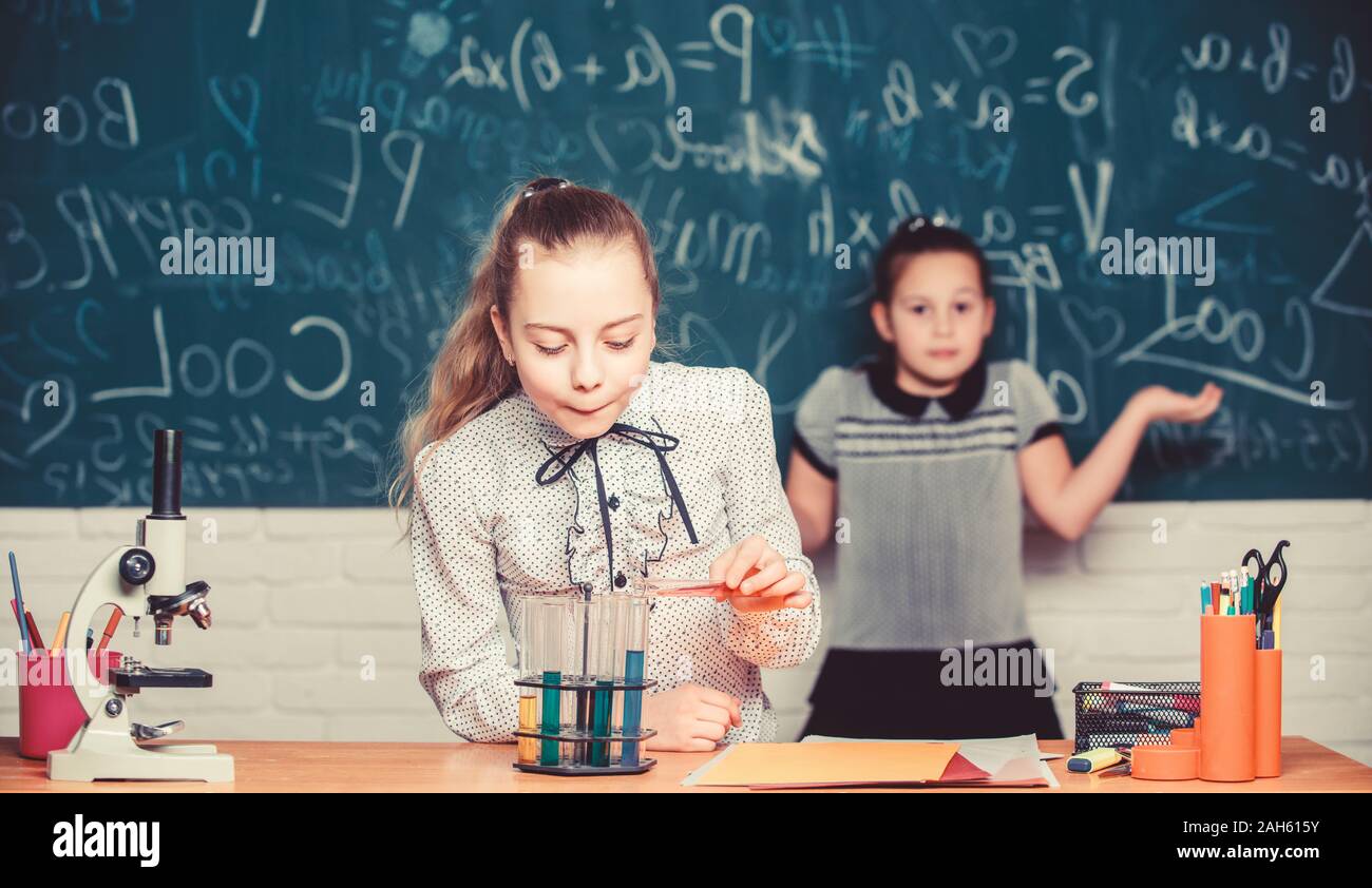 Focusing on work. Chemistry research. Little girls in school lab. Formal school education. Biology school lesson. Little scientist work with microscope. science experiments in laboratory. Stock Photo