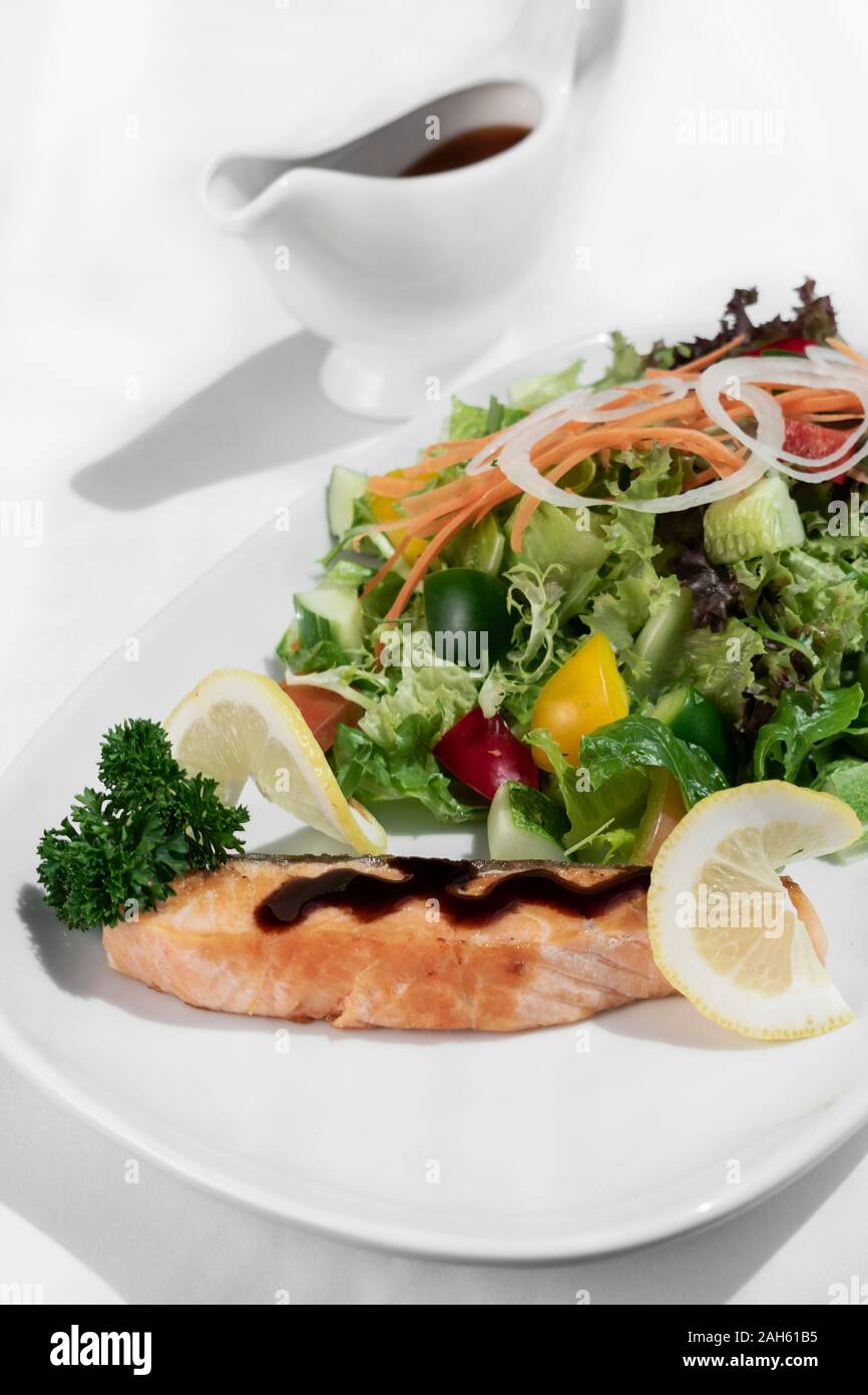 organic mixed vegetable salad with salmon fillet and balsamic