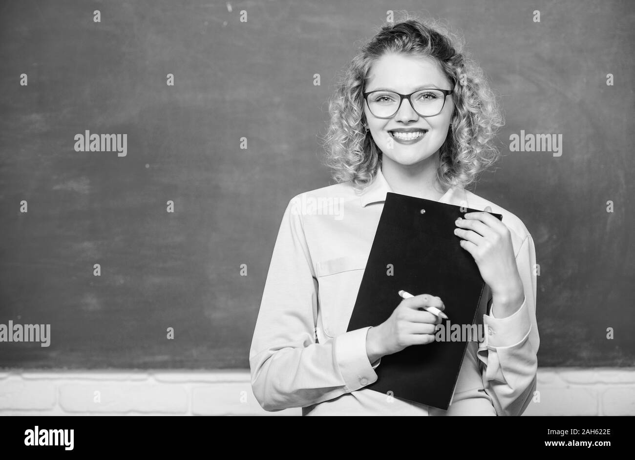 Inspire. teacher with document folder. girl teacher at school lesson. happy student in glasses at blackboard. report project. back to school. new school year. Girl prepare for exams. copy space. Stock Photo