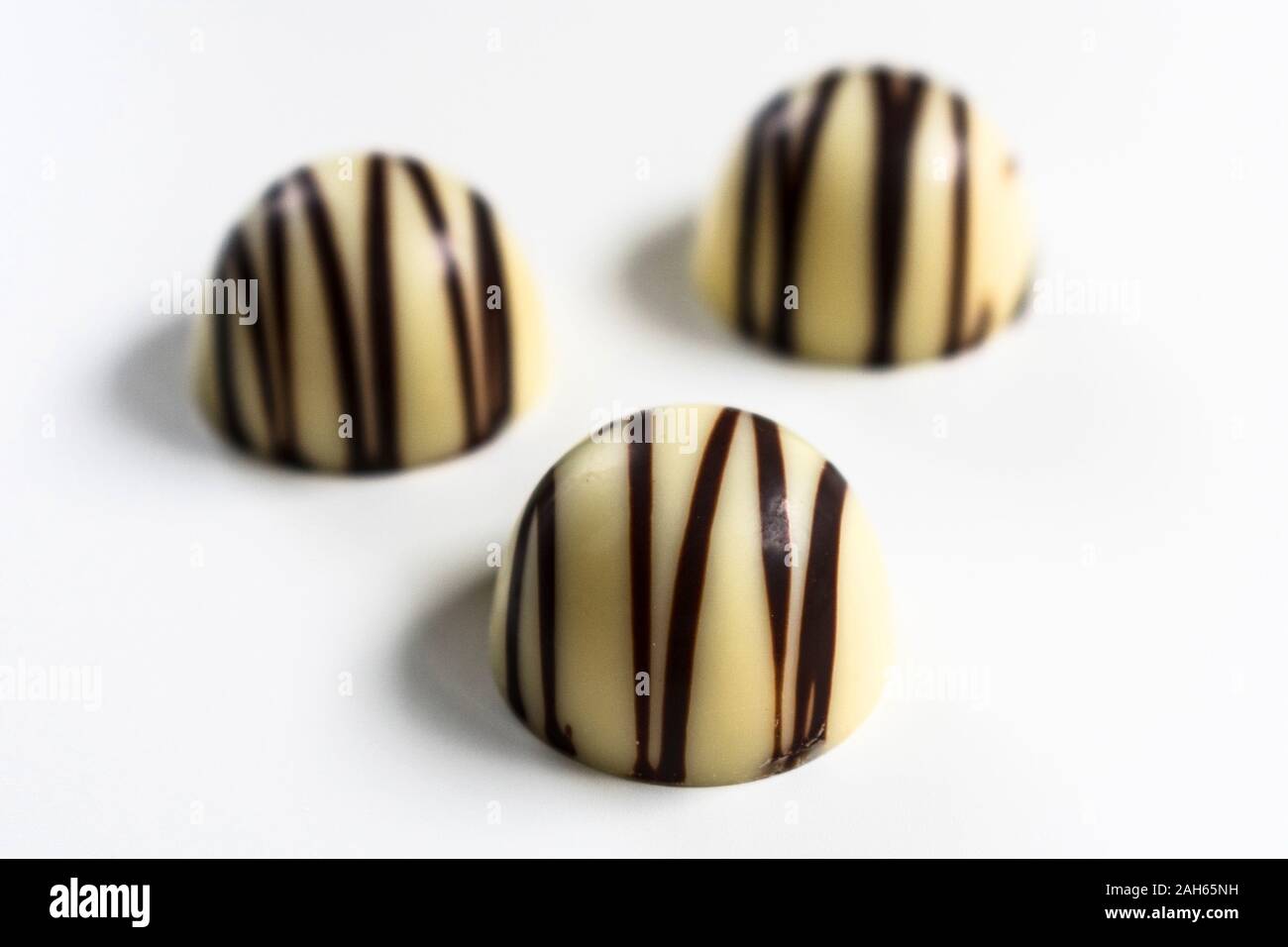 Three white chocolate candies isolated on a white background. Stock Photo
