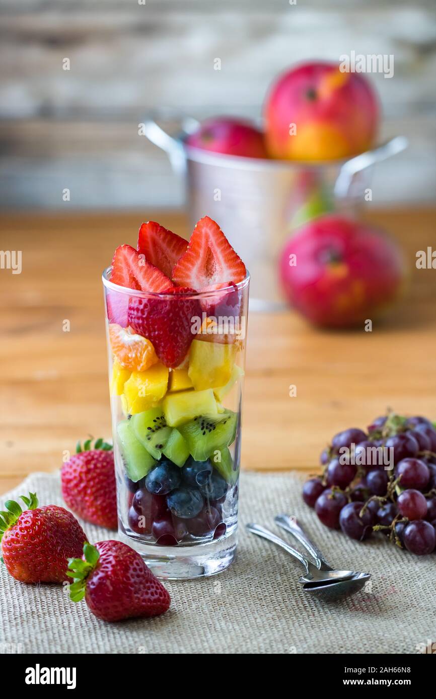 Rainbow fruit salad in glass. Stock Photo