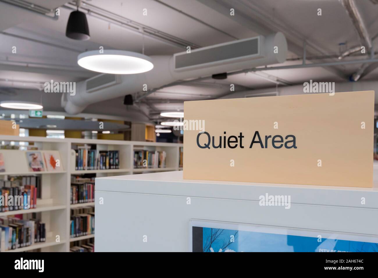 A shelf top sign reminds people that they are in a Quiet Area in the new Exchange Building that houses a restaurant and the City of Sydney Library Stock Photo
