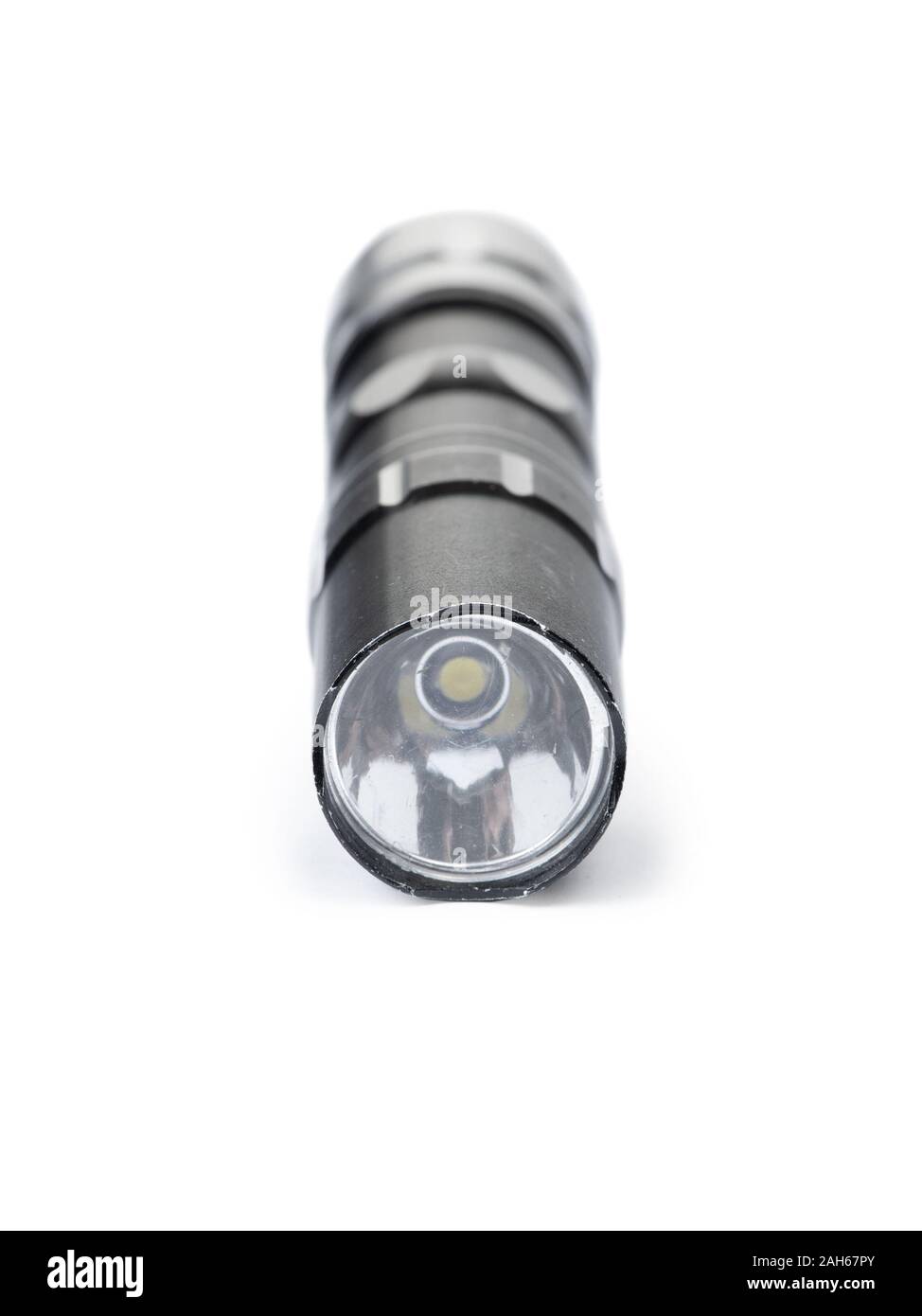 Old black flashlight isolated on white background Stock Photo