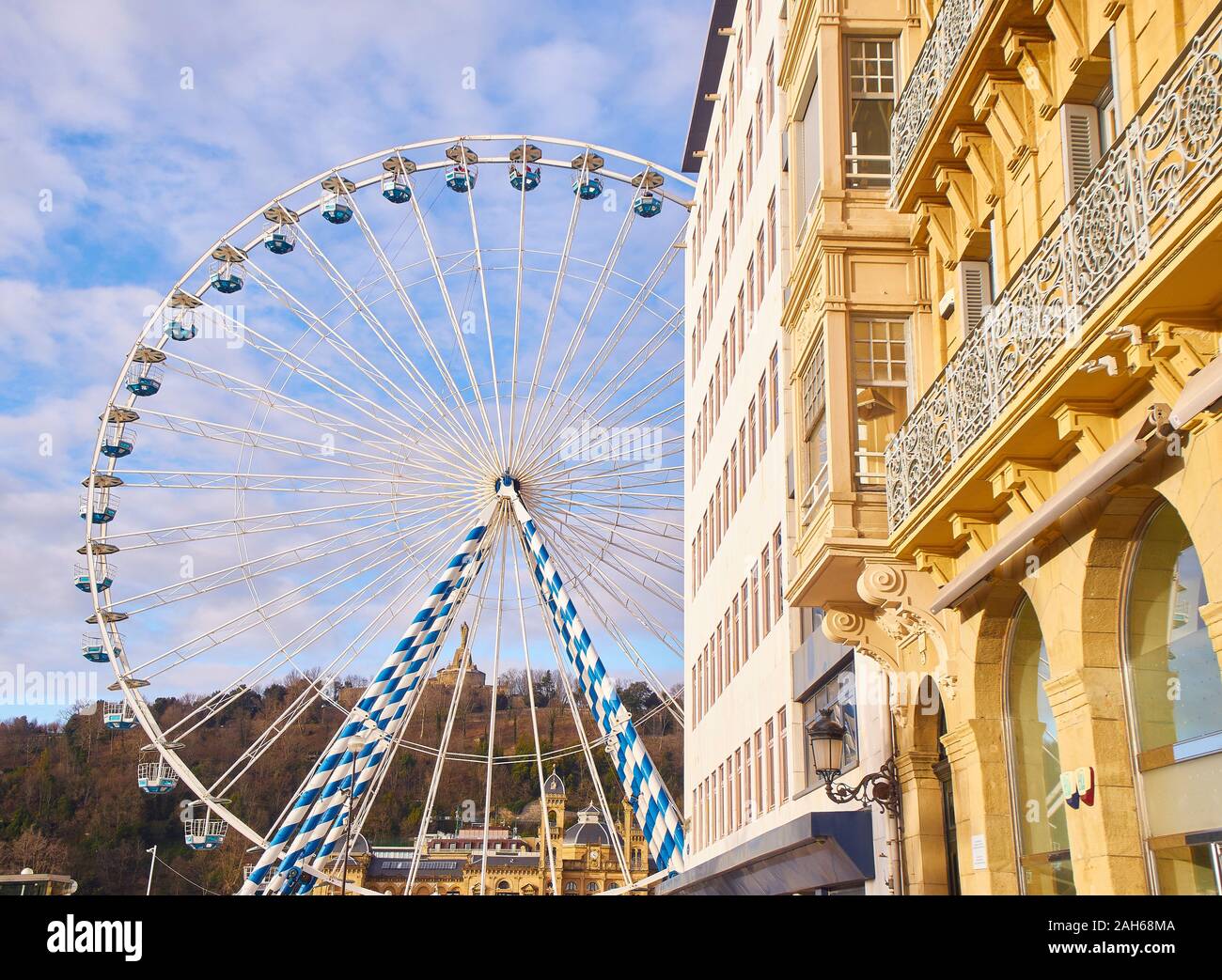 A Ferris wheel in the city of San Sebastian. View from Miramar street. Basque Country, Guipuzcoa. Spain. Stock Photo