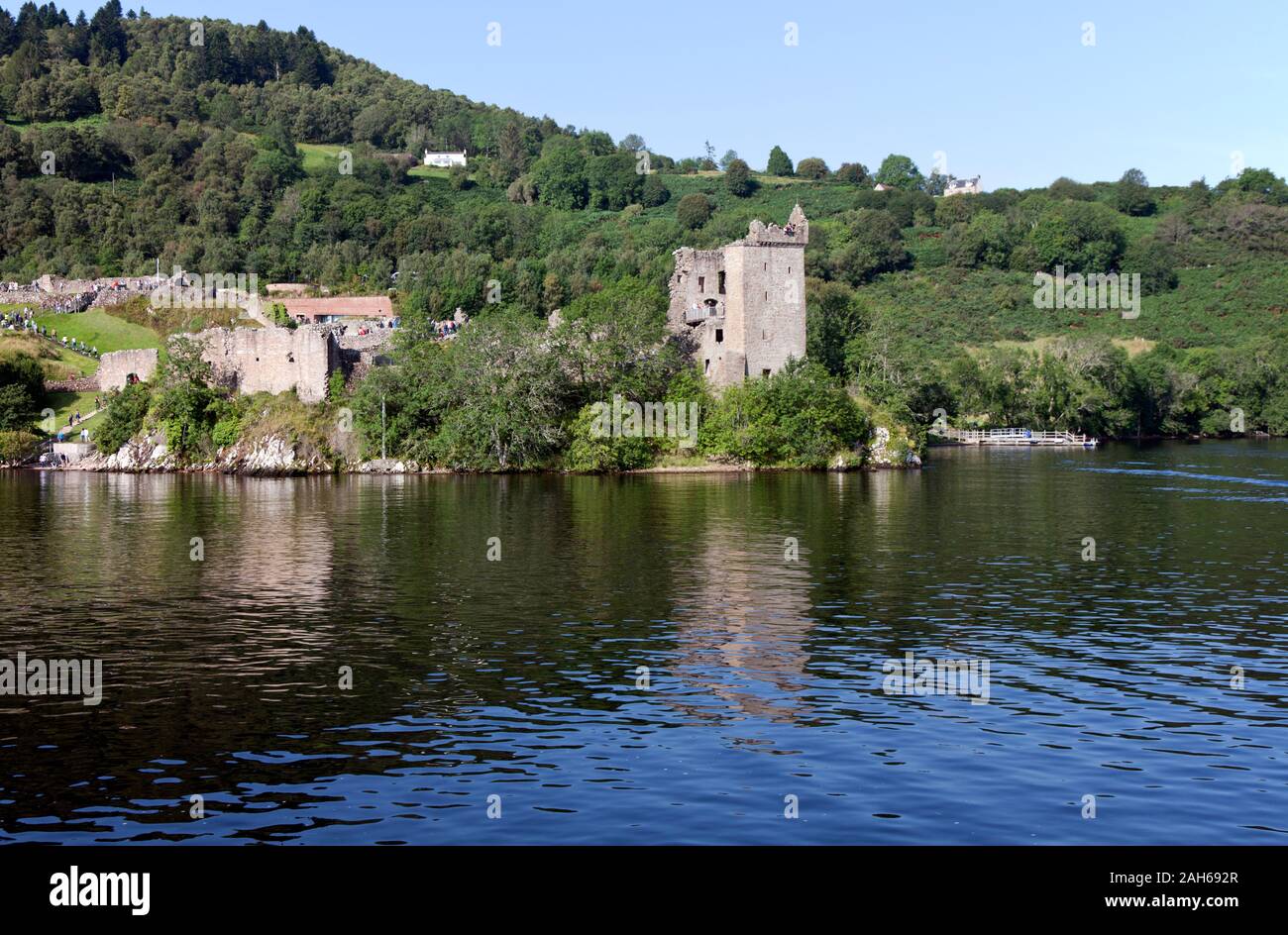 Holding some 1000 years of history, the ruins of Urquhart Castle at the edge of Loch Ness in the Scottish Highlands now draw hundreds of tourists dail Stock Photo
