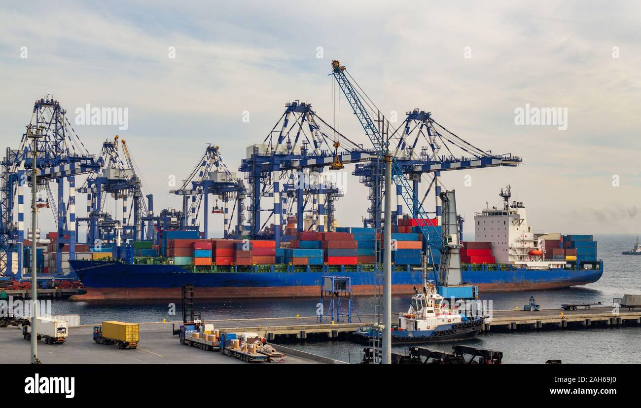 Commercial freight transport. Shipping cargo to harbor by crane. Sea transport International. Container ship in export and import business and logist Stock Photo