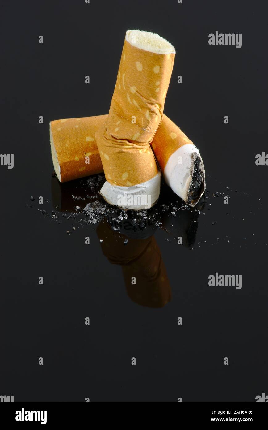 Crushed cigarette butts isolated on black background Stock Photo