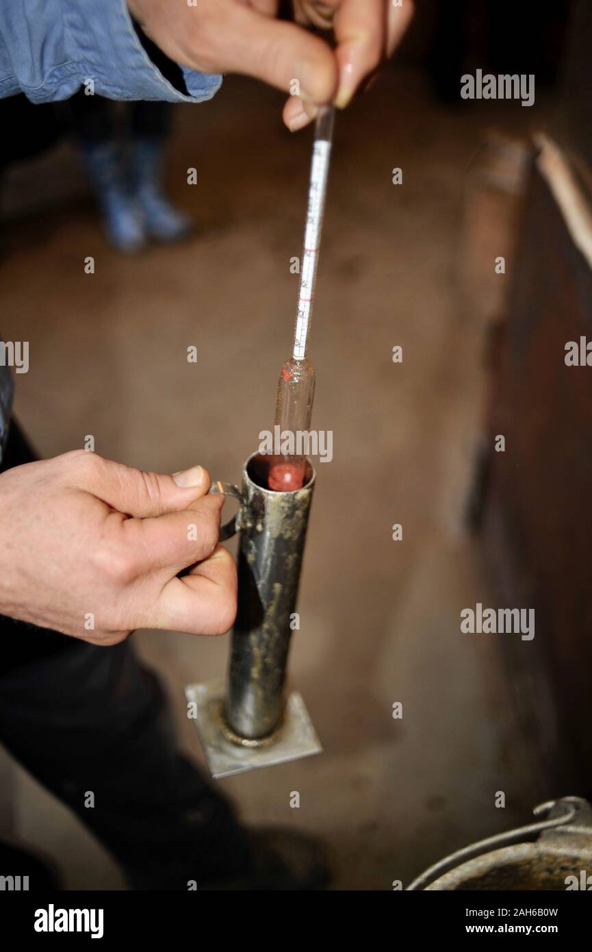 Testing the maple syrup with a hydrometer, pulled from the heated