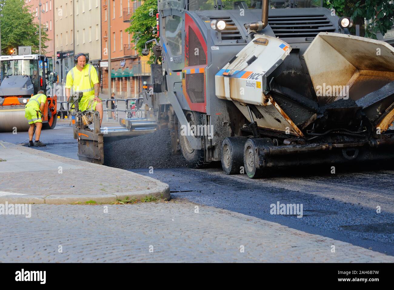 Karlstad, Sweden - June 19, 2019: The construction comapany NCC laying asphalt in the city center. Stock Photo