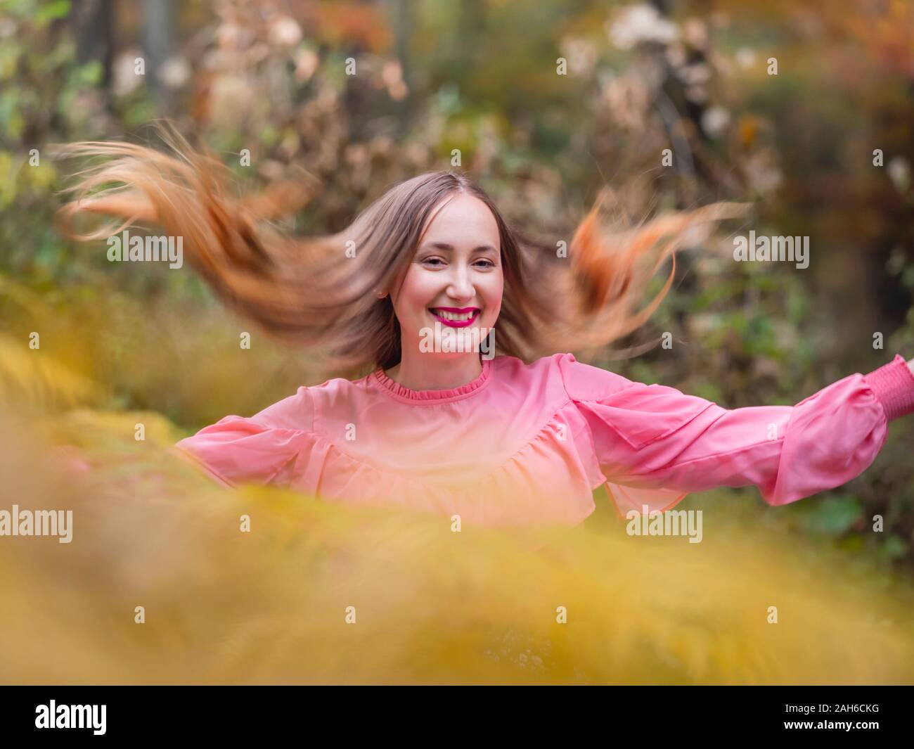 Country-girl countrygirl in countryside flying her hair wide apart portrait isolated partially blurry for happiness Stock Photo